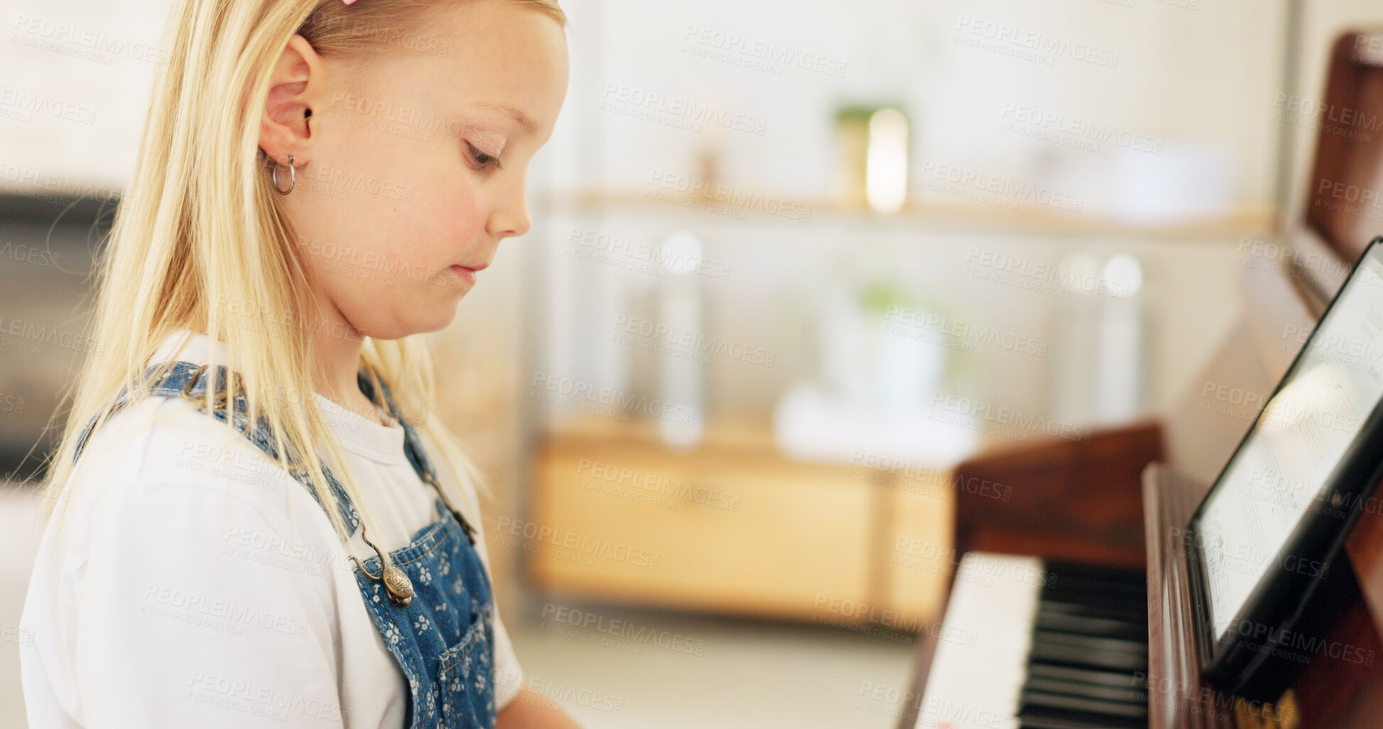 Buy stock photo Child, piano music and learning instrument at home with development, keys or tablet. Little girl kid, practice space or student playing notes for pianist lesson, training and musician talent at house