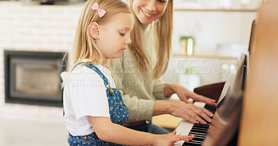 Music development, girl learning piano and musical note education from mom in the home living room. A child musician playing keys, learn creative audio art and fun concert performance in family house