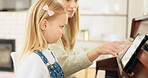 Music development, girl learning piano and musical note education from mom in the home living room. A child musician playing keys, learn creative audio art and fun concert performance in family house