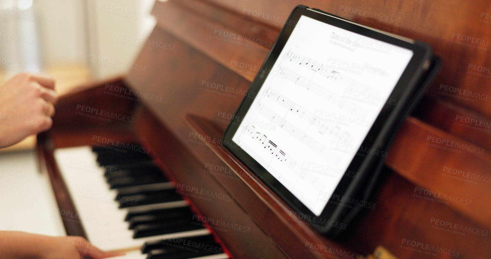 Buy stock photo Hands, tablet and piano with sheet music for a song closeup during a lesson in a home or classroom. Professor, student and teaching with technology for a musical theatre production at art school