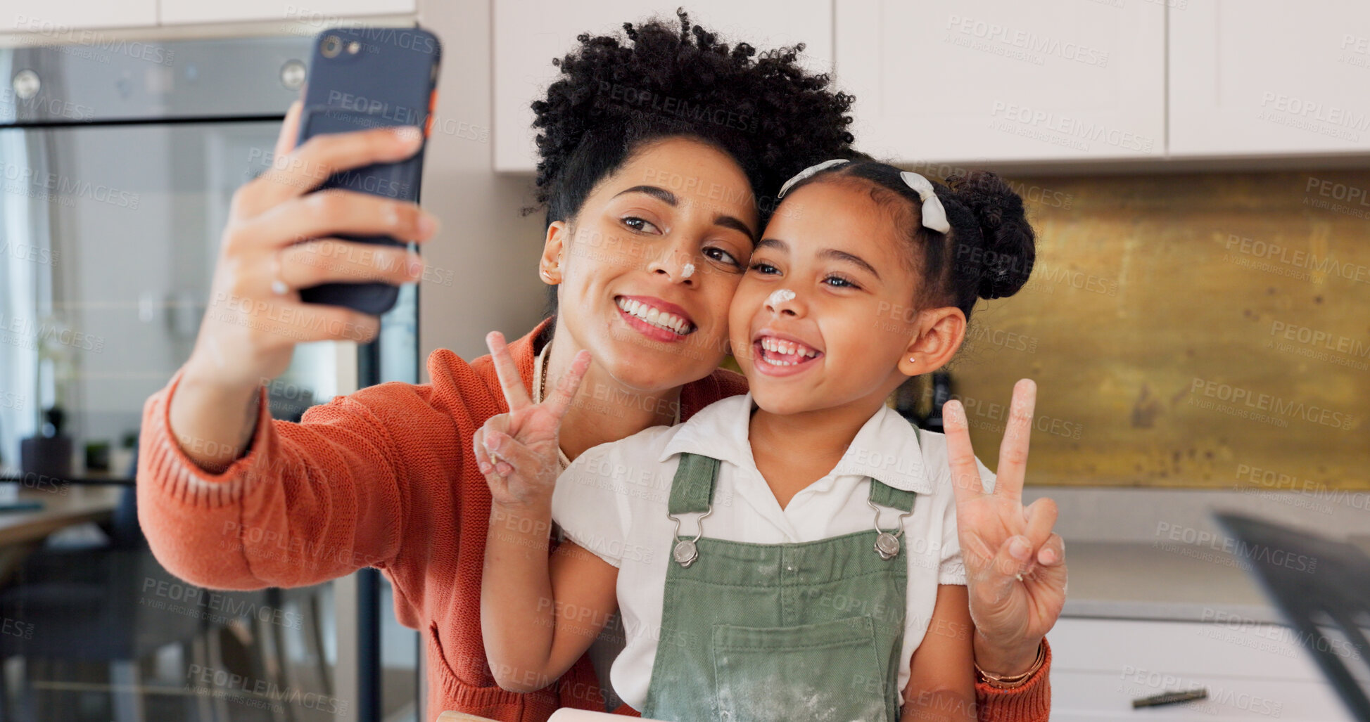 Buy stock photo Mom, girl and selfie in kitchen, peace sign and smile with funny face, memory and post on web. Photography, mother and daughter with baking, learning or happy with food, social media or flour on nose