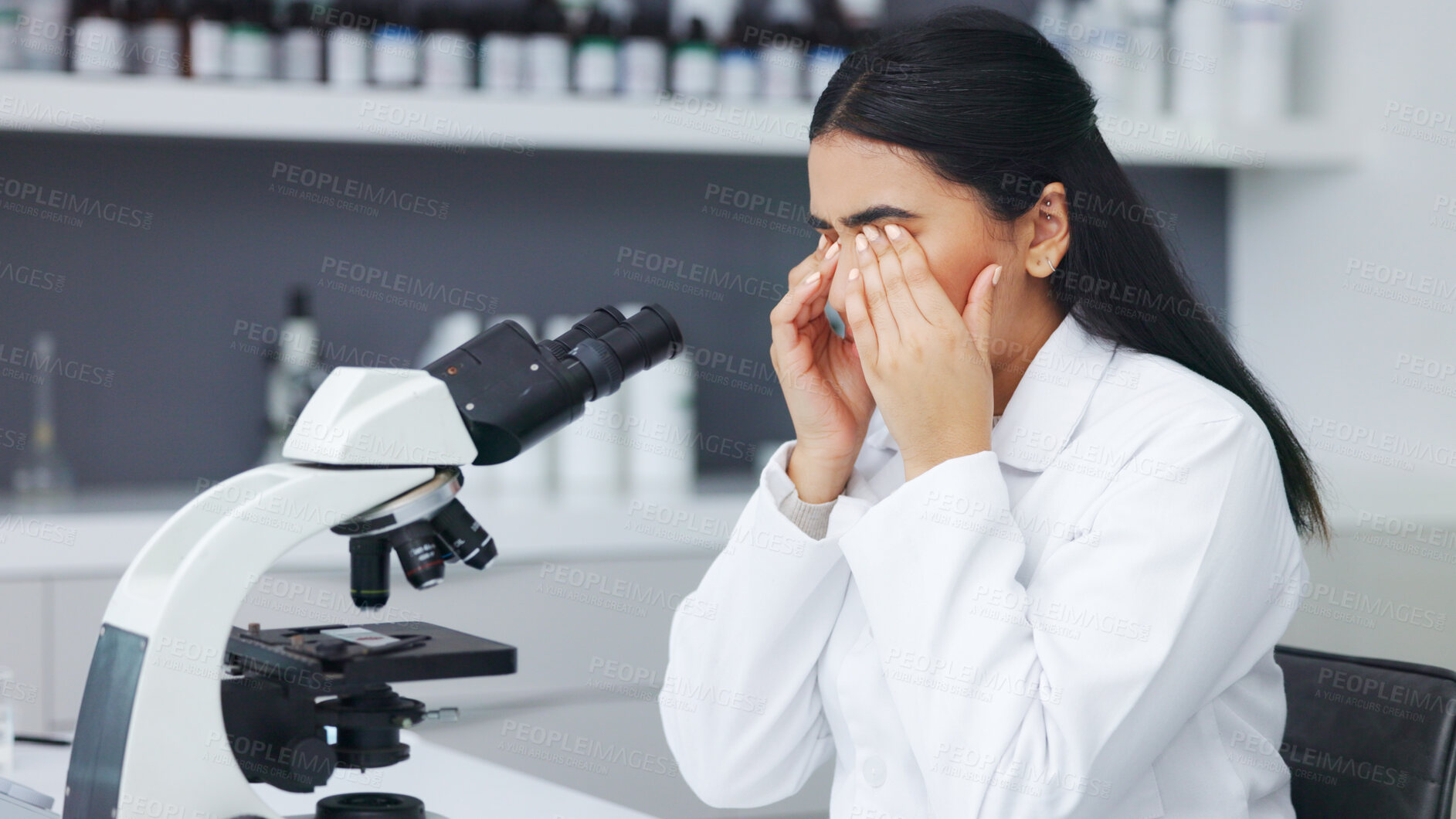 Buy stock photo Microscope, scientist and woman with fatigue, tired and rubbing eyes for burnout. Stress, headache and science professional with pain, frustrated and exhausted at medical research in laboratory.