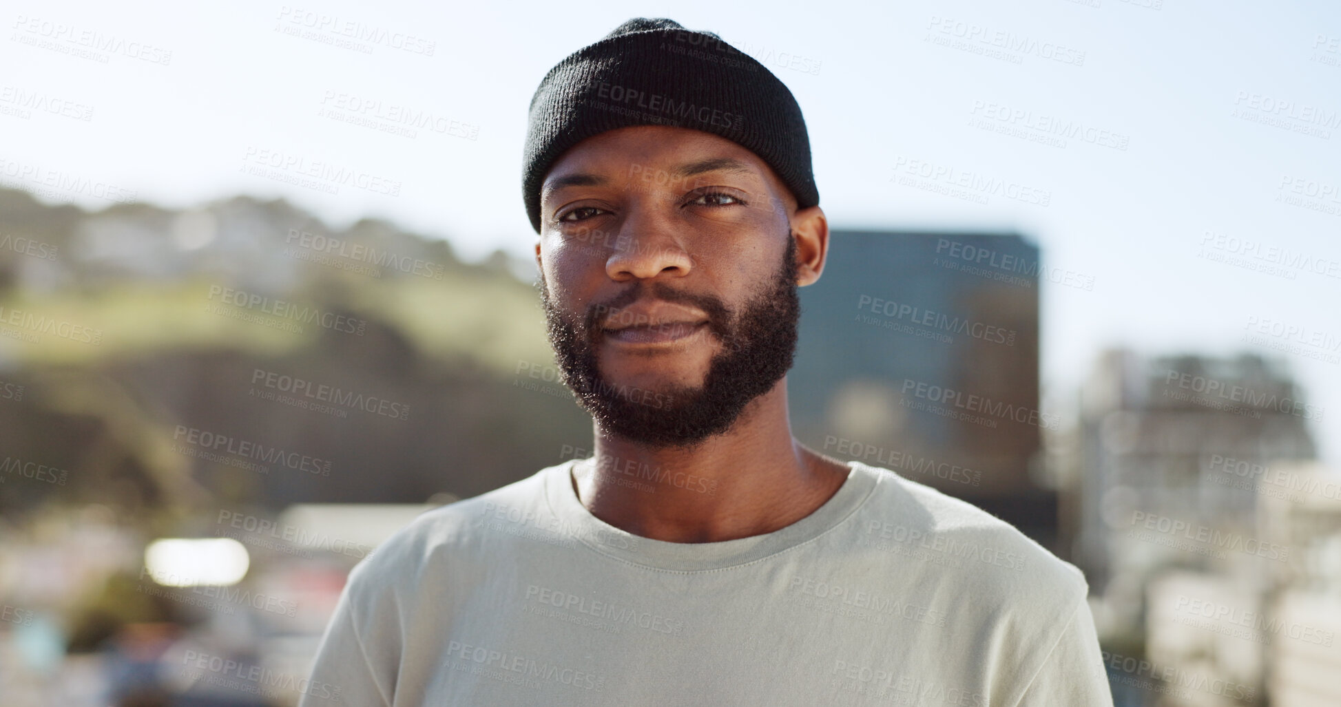 Buy stock photo Portrait, confident and a black man in the city on a roof during summer for fashion or style. Face, serious and a cityscape of buildings with a young person outdoor for freedom in an urban town