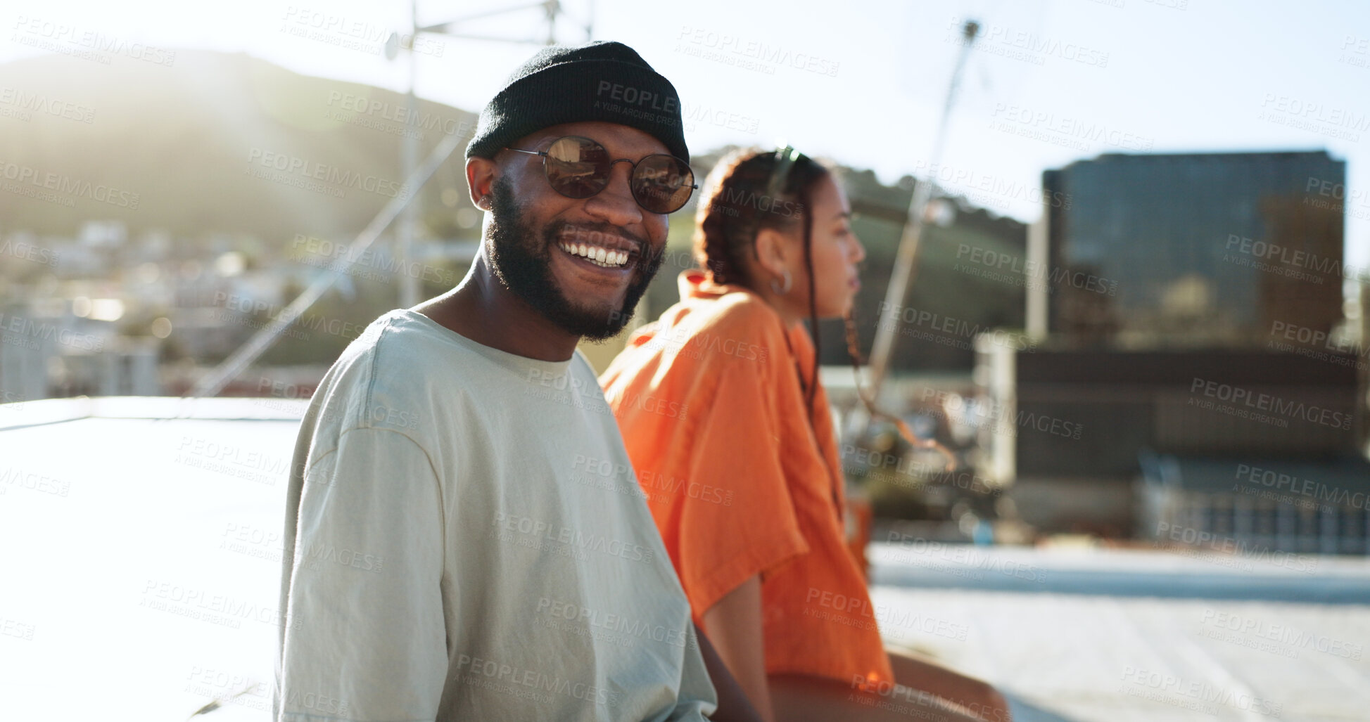 Buy stock photo Black man, smile and glasses on city rooftop outdoor in summer, Portugal holiday or vacation location with style, portrait or cool clothes. Happiness, tourist and person sightseeing with woman friend