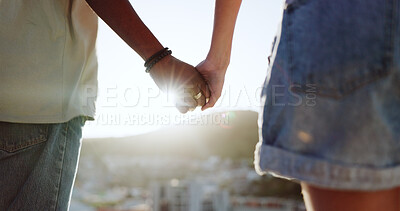 Buy stock photo Holding hands, relax and flare with an interracial couple on the beach at sunset for romance or dating. Nature, freedom or love with a man and woman closeup on the coast together for holiday travel