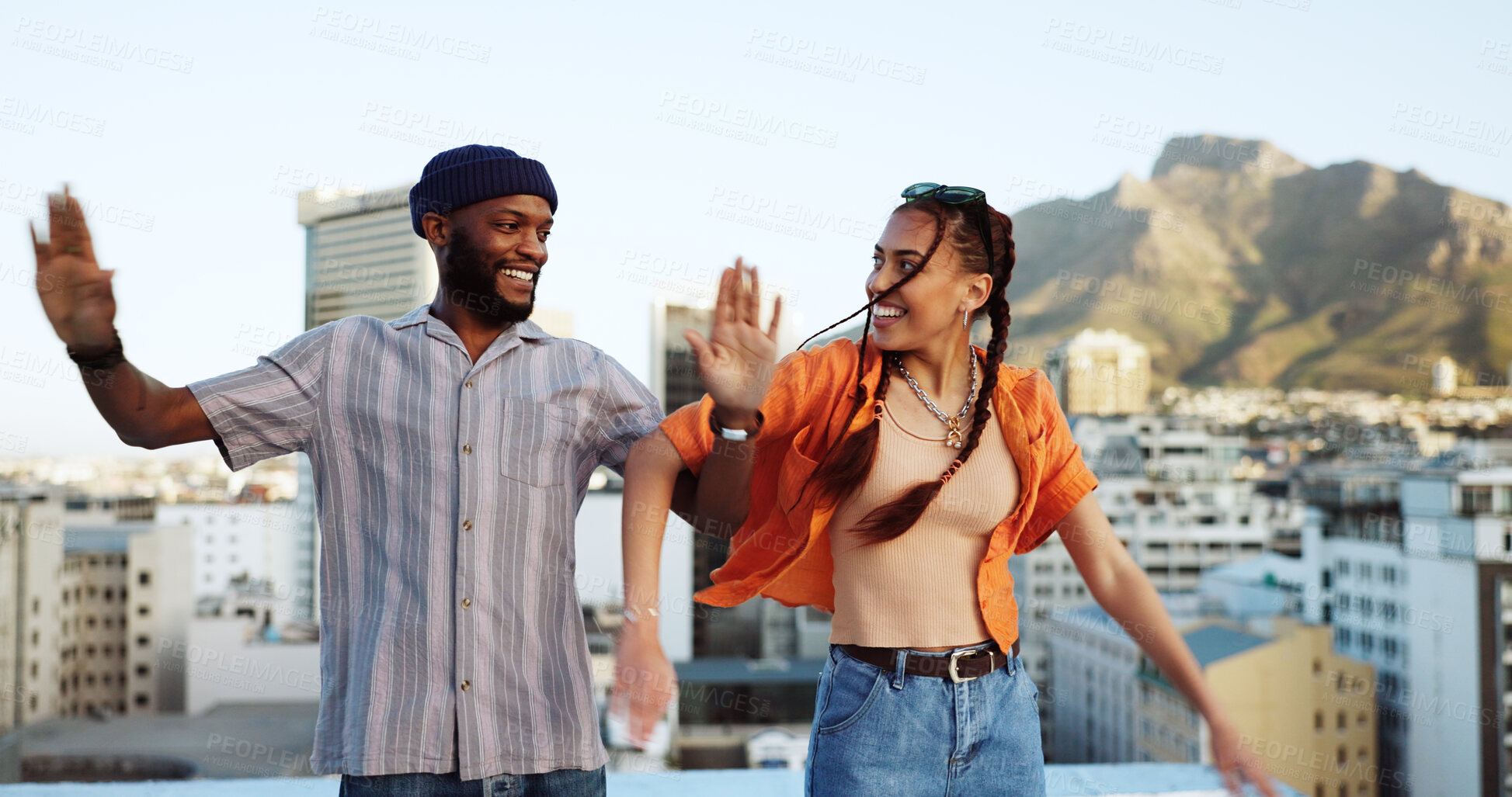 Buy stock photo Couple of friends, dance and outdoor on city rooftop with fun energy, love and happiness. African man and trendy gen z woman dancer together for travel, urban date and freedom or relax in Cape Town