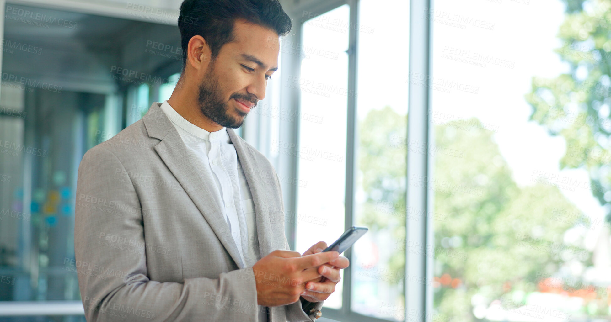 Buy stock photo Business, window and man with a cellphone, typing and email notification with digital app, network and social media. Happy person, employee or consultant with a smartphone, mobile user and connection