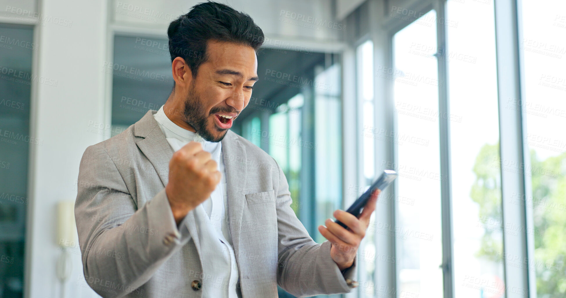 Buy stock photo Celebrate, success and phone of business man in office for good news or yes feedback. Excited, winning and fist of asian male employee with smartphone for wow achievement, promotion or online bonus