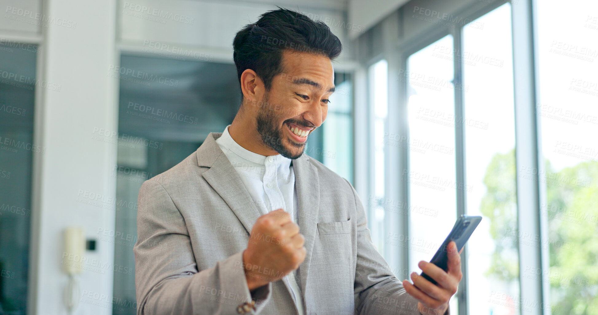 Buy stock photo Celebrate, winner and phone of business man in office for good news or yes feedback. Success, excited and fist of asian male employee with smartphone for wow achievement, promotion or online bonus