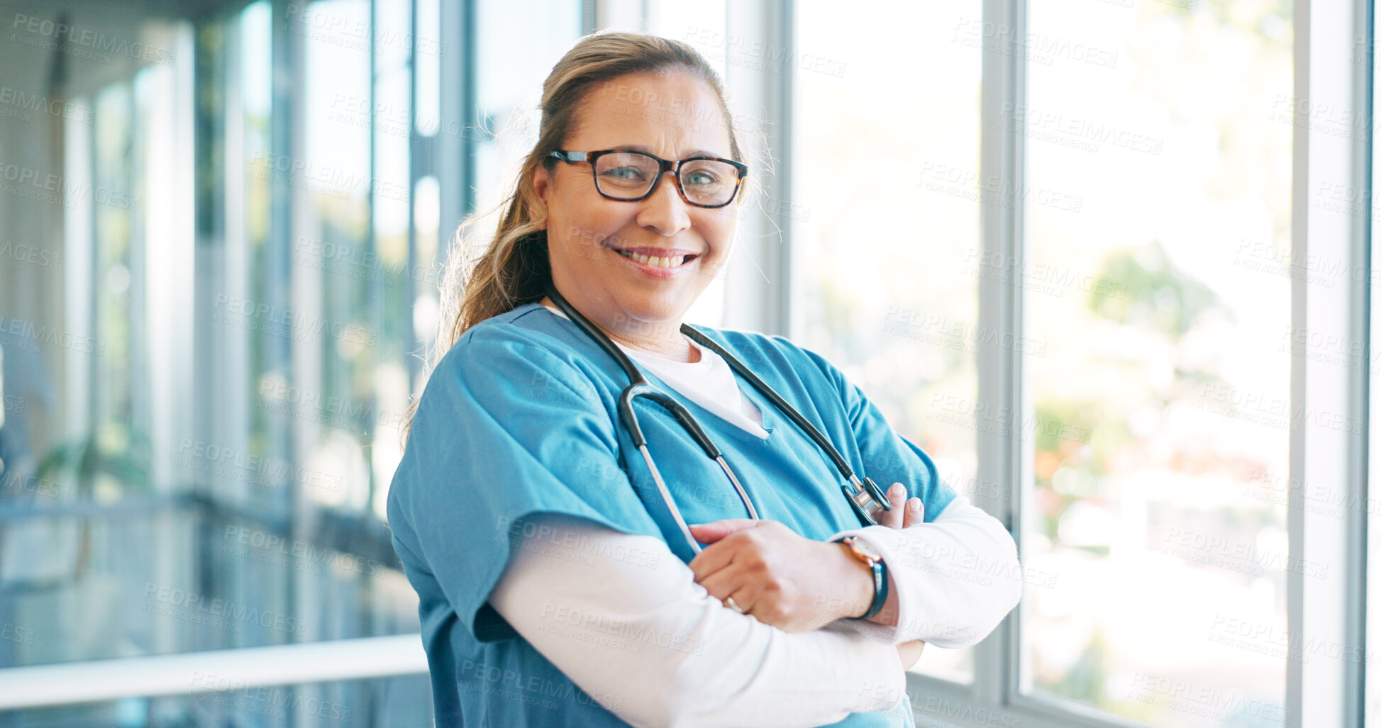 Buy stock photo Nurse in portrait, woman with arms crossed and health, smile with confidence at hospital with pride and help. Medical professional, trust and expert caregiver at clinic with scrubs and medicine