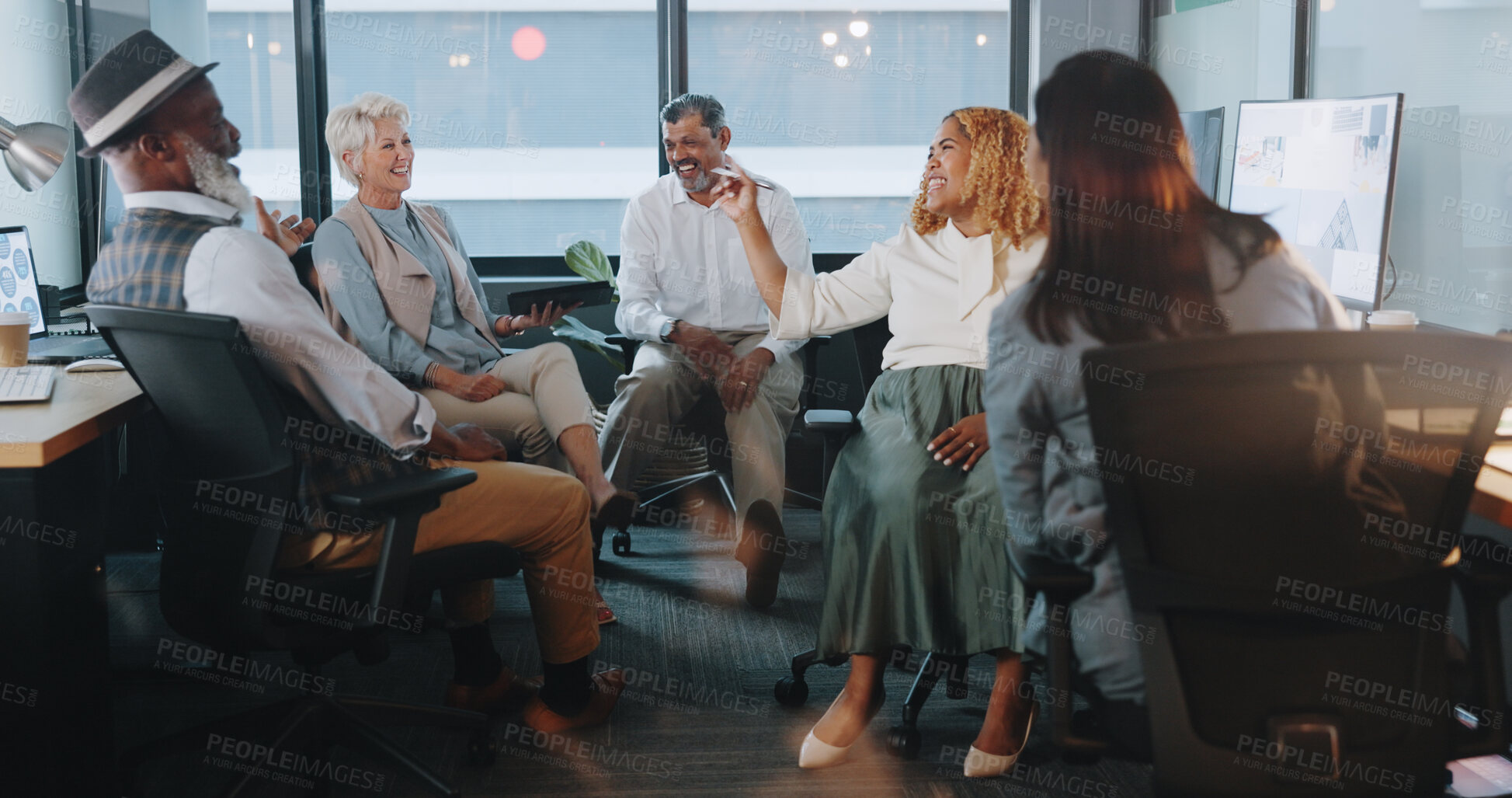 Buy stock photo Creative people, meeting and laughing at night for funny joke in team building or project planning at office. Group of employees working late in fun teamwork discussion, startup or deadline together