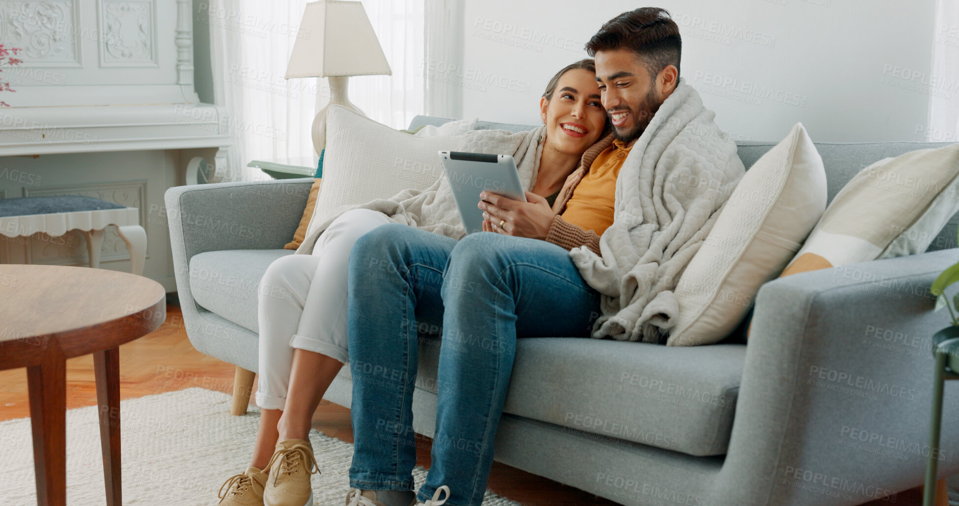 Buy stock photo Happy couple, relax and streaming with tablet in home and scroll on social media, communication or together on sofa. Watching tv, video or online with man and woman with blanket and tech in apartment