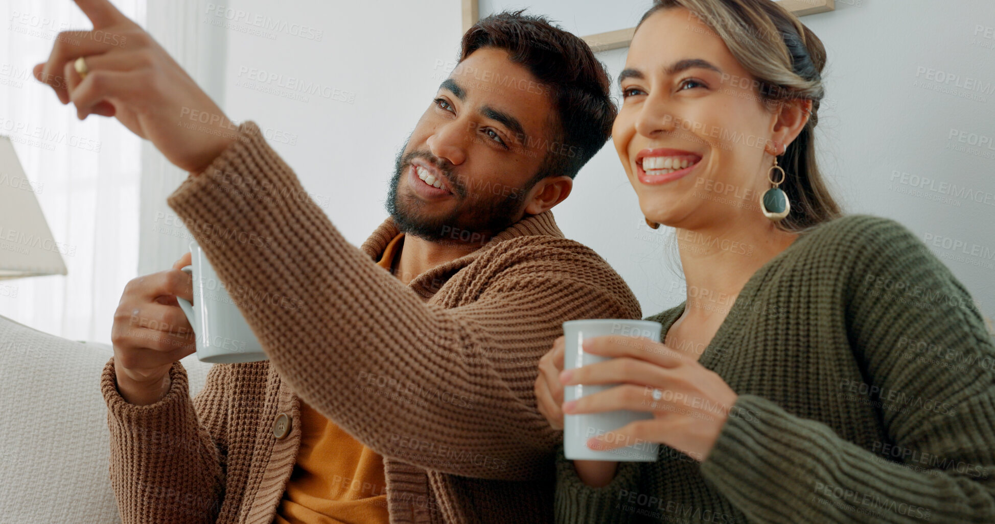 Buy stock photo Relax, coffee and a couple pointing at the tv in the living room together for streaming. Love, smile or happy with a man and woman watching television on a sofa at home for subscription entertainment