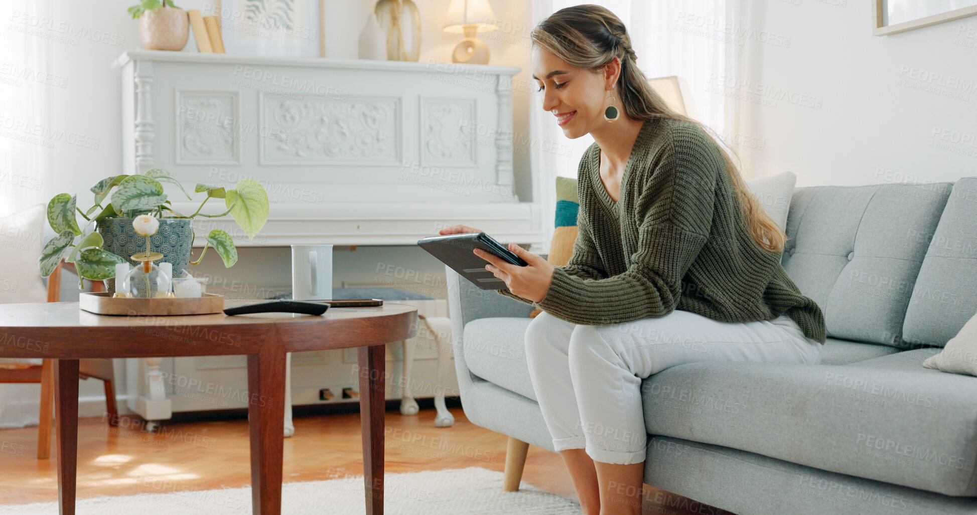 Buy stock photo Happy woman, relaxing and smile with tablet in home while browsing, reading or online shopping. Canadian person, alone and casual with technology on sofa for internet, social media or mobile app 