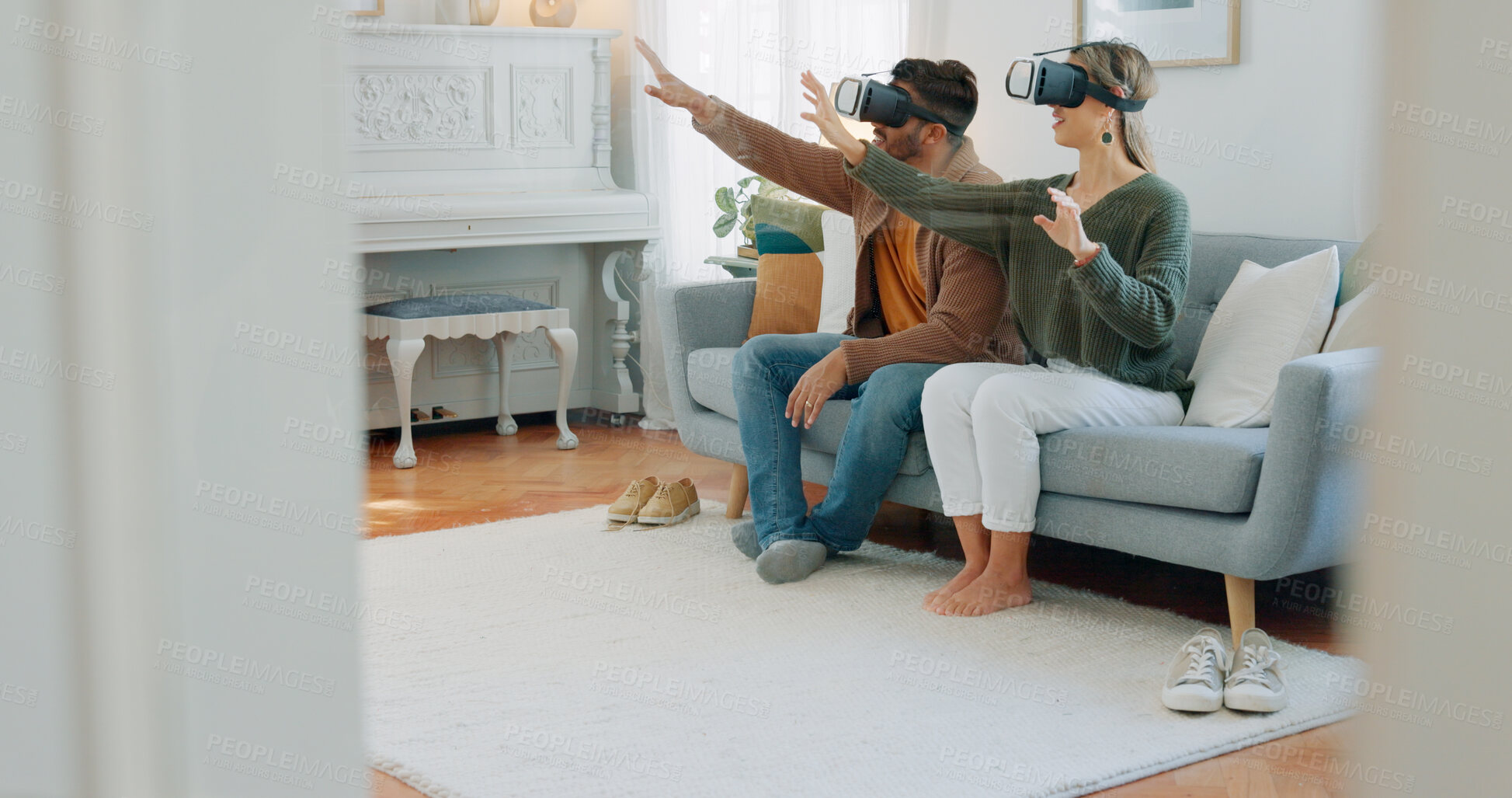 Buy stock photo Virtual reality gesture, home and couple playing video game, augmented reality and design living room on multimedia system. AI, VR metaverse simulation or people gaming on interactive user experience