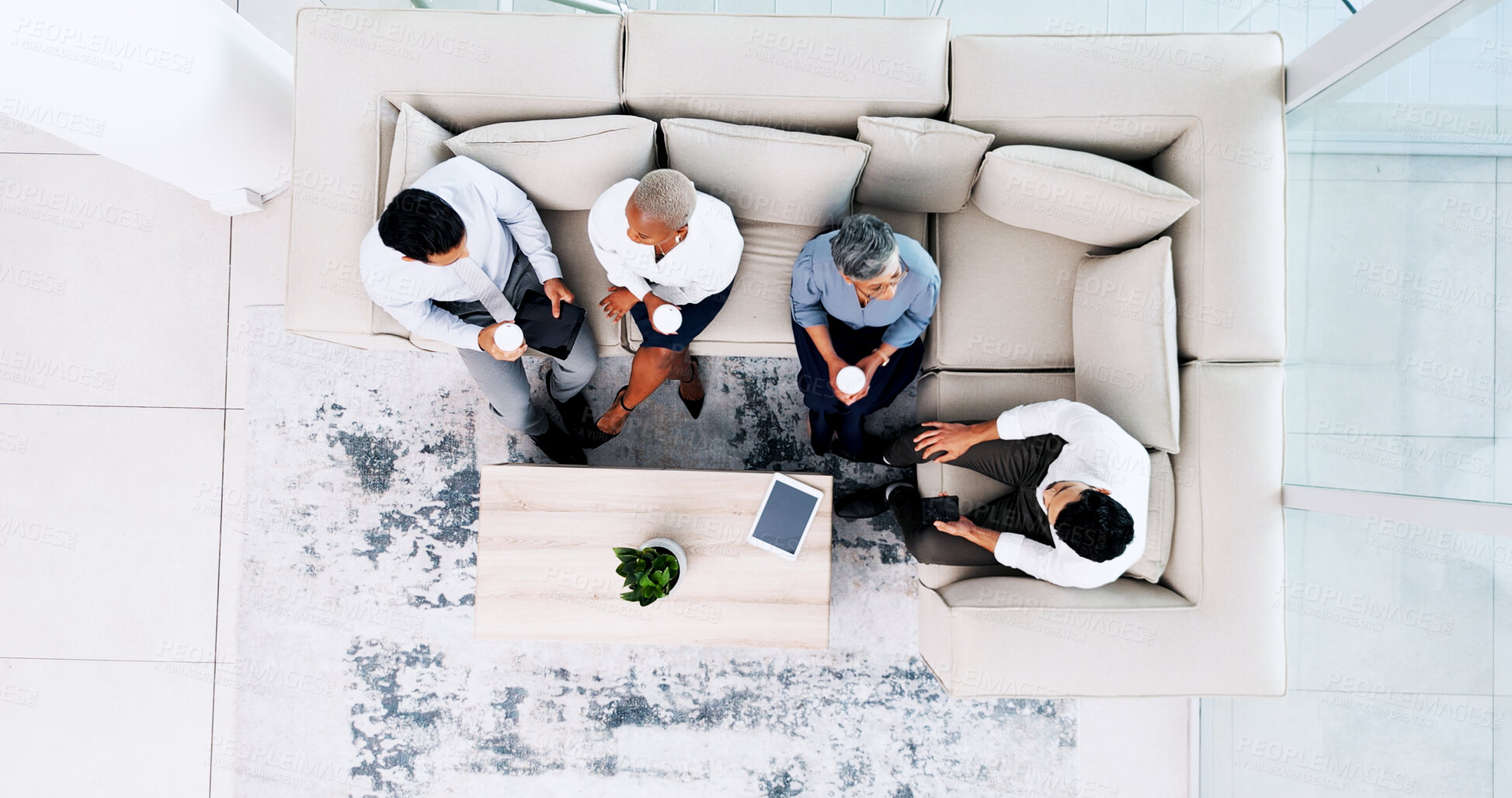 Buy stock photo Business people, meeting and relax in lounge at office for lunch break, collaboration or team building above. Top view of employees in social discussion or collaboration on sofa together at workplace