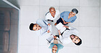 Collaboration, overhead and huddle with a business team laughing while working together in an office. Face, teamwork and documents with a man and woman employee group standing in a circle from above