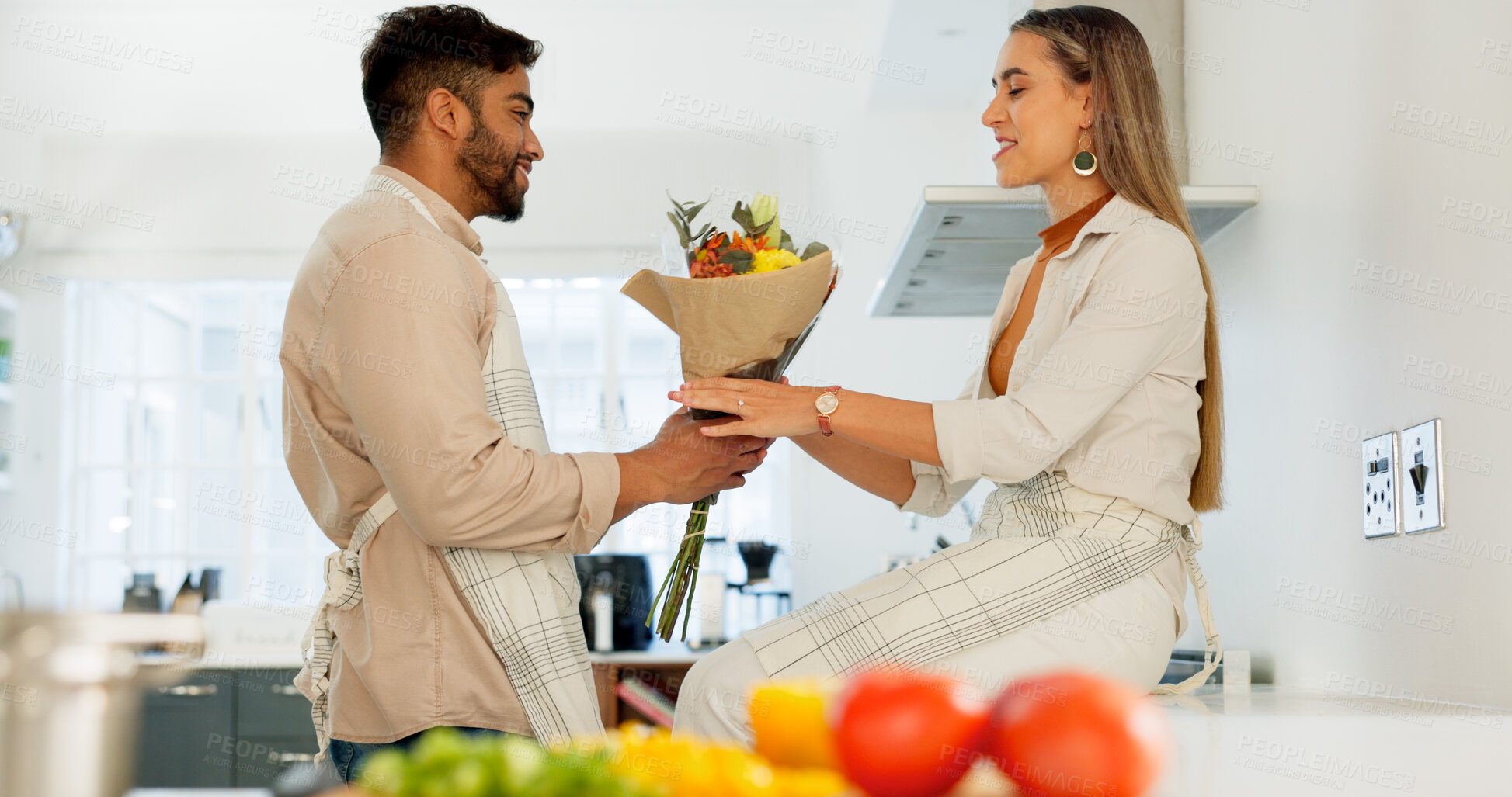 Buy stock photo Love, flowers or surprise with a couple in the kitchen of their home together for romance on valentines day. Wow, smile or happy with a man and woman in the house for celebration of their anniversary