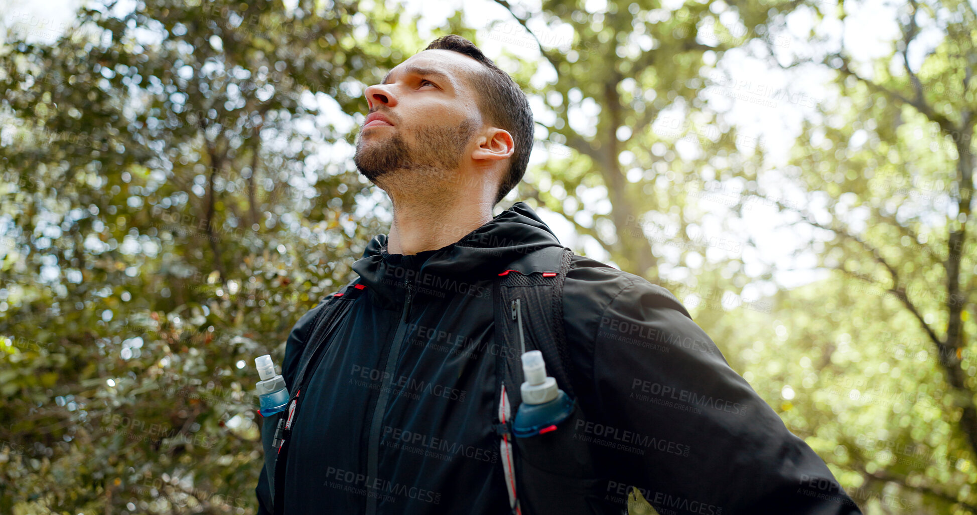 Buy stock photo Thinking, hiking and man in nature forest or woods for workout, training and exercise. Serious person, water and athlete backpacker outdoor for fitness or trekking adventure with trees for wellness