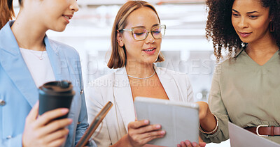 Creative business woman, tablet and discussion for marketing, advertising or team strategy at the office. Group of employee women in teamwork, collaboration or conversation on touchscreen for startup