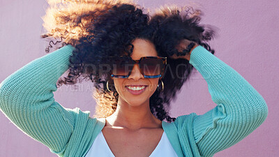 Hair care, fashion sunglasses and black woman happy in summer, smile for summer curls and excited about luxury glasses against pink city wall. Portrait of comic girl with curly hair on street