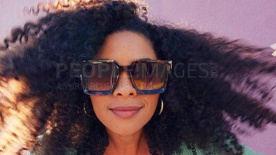 Hair care, fashion sunglasses and black woman happy in summer, smile for summer curls and excited about luxury glasses against pink city wall. Portrait of comic girl with curly hair on street