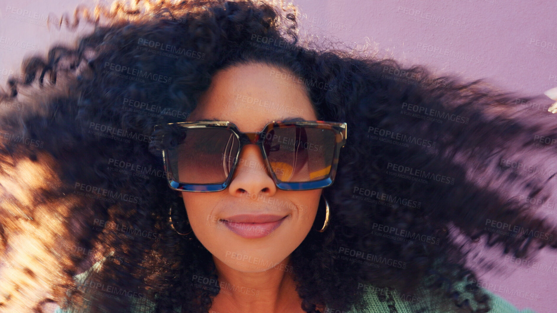 Buy stock photo Black woman, crazy hair and happy with closeup on pink background by wall with freedom. Fashion, style and trendy sunglasses with outfit of female person with afro hairstyle outdoor haircare and wind