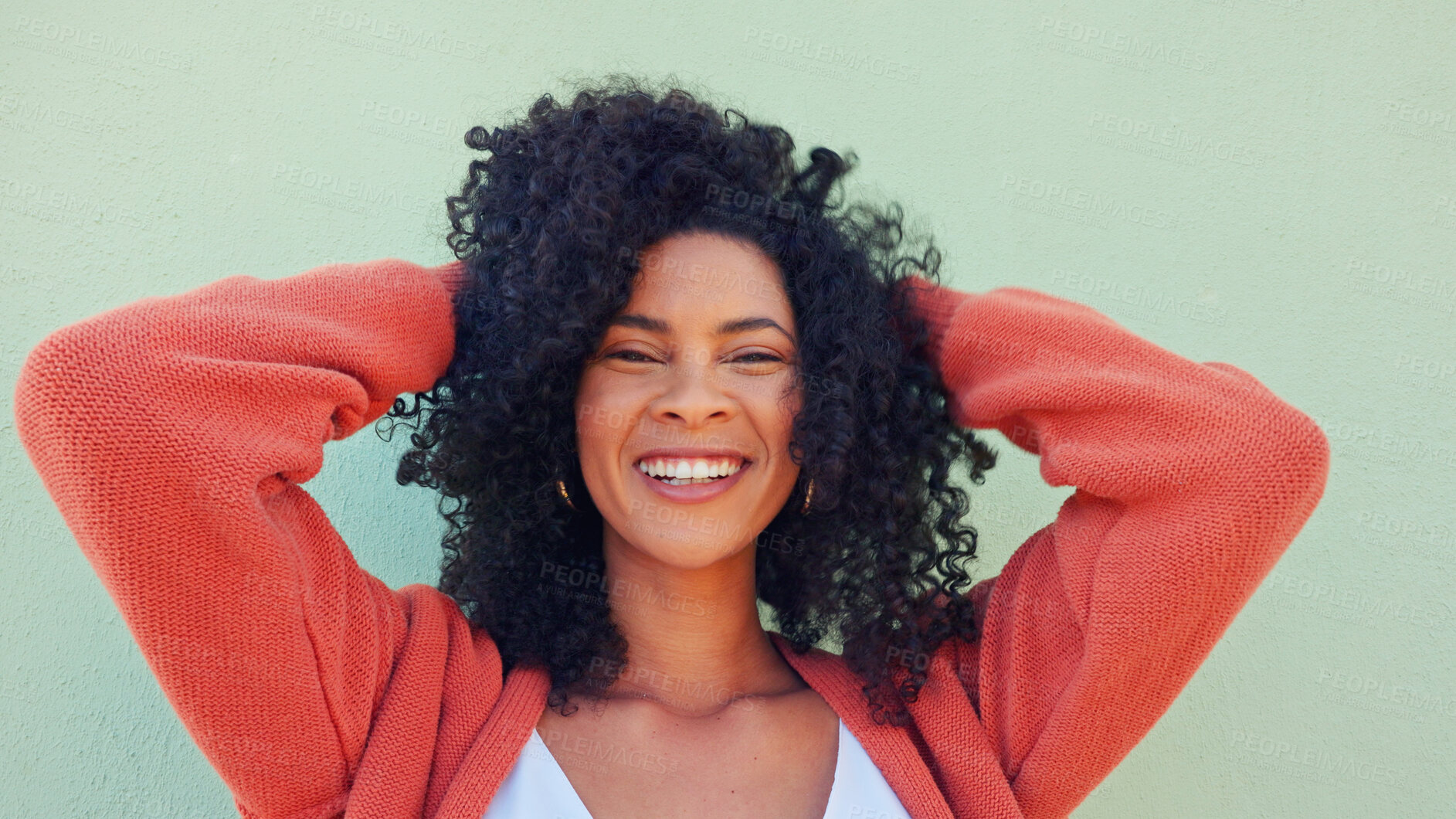 Buy stock photo Woman, hands and curly hair with portrait or smile at wall for beauty, natural or cosmetic. Black female, wellness and happiness for treatment results or care for relax, positive or laughing or fresh