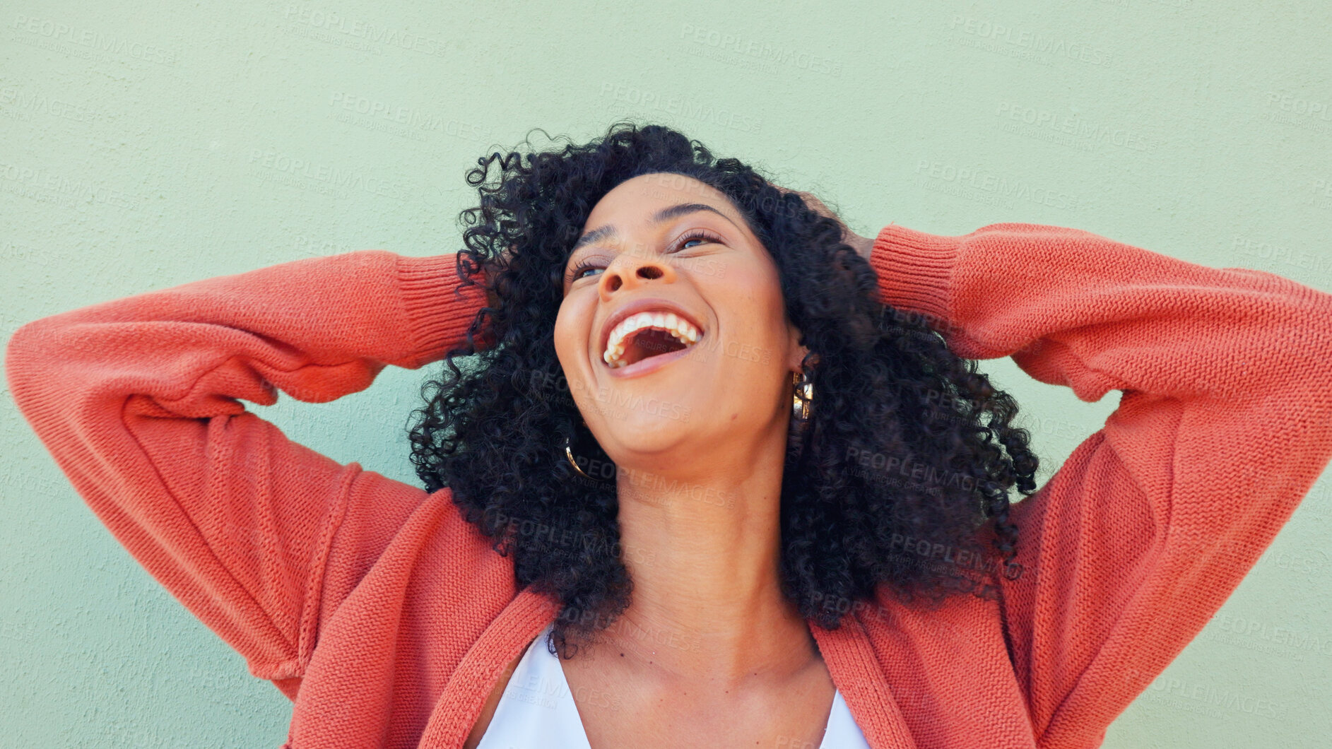 Buy stock photo Woman, hands and play with hair for beauty or wellness with smile at green wall, energy or cosmetic. Black female, happiness and care for curly treatment for healthy results for laughing with freedom