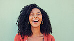 Smile, laughing and happy black woman on green wall background. Portrait face of funny, young and comedy young female with natural afro hair, freedom and happiness for life, motivation and crazy joke