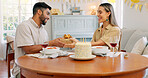 Interracial, couple and celebrate for birthday with gift, being happy and relax together at party. Romance, man and woman with present, bonding and smile in home in living room for hug or celebration