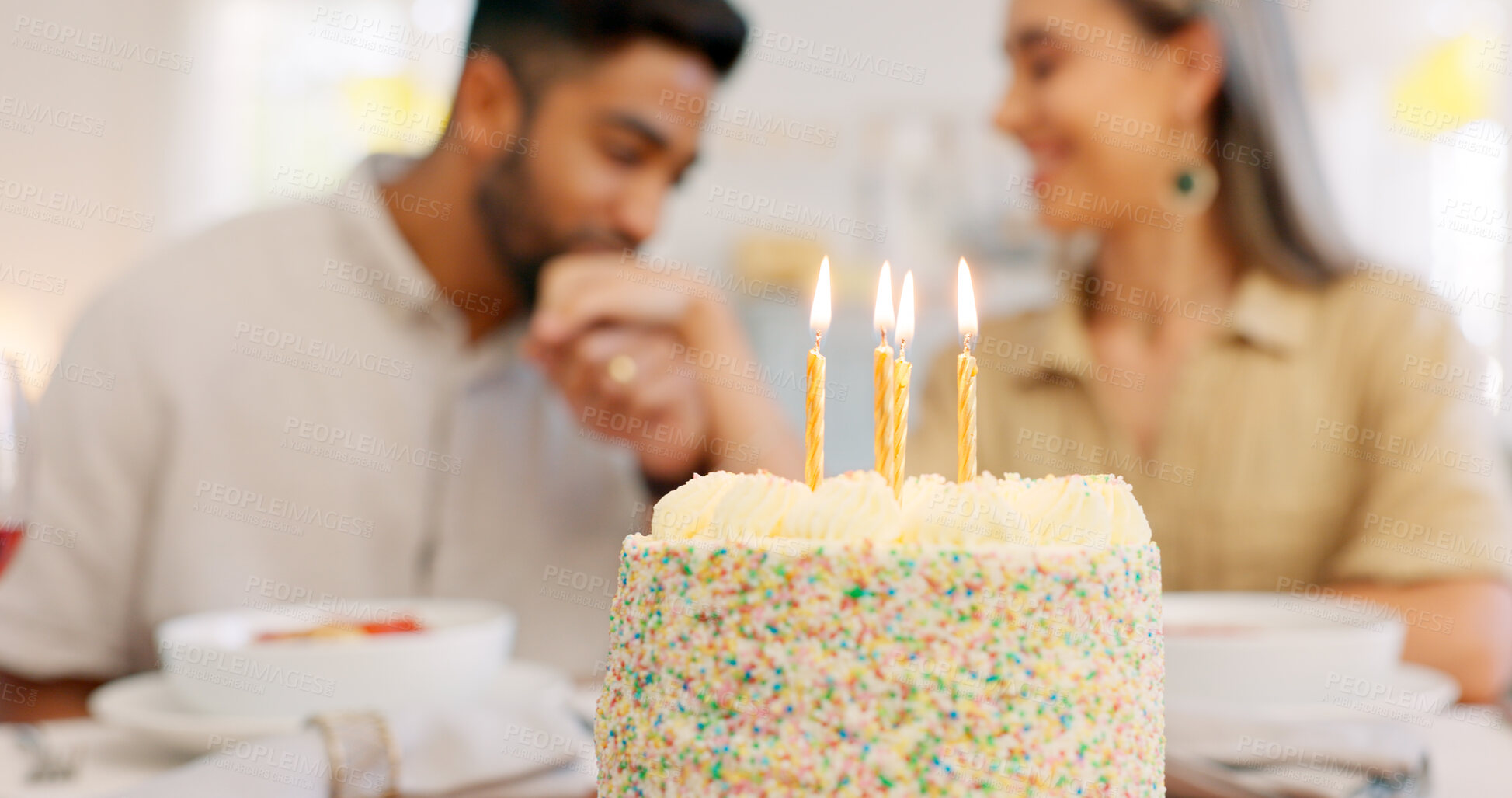 Buy stock photo Cake, anniversary or birthday, with couple celebration and hand kiss together with love at home. Candles, smile and happy people blur with dinner date and food in a house with support and care 