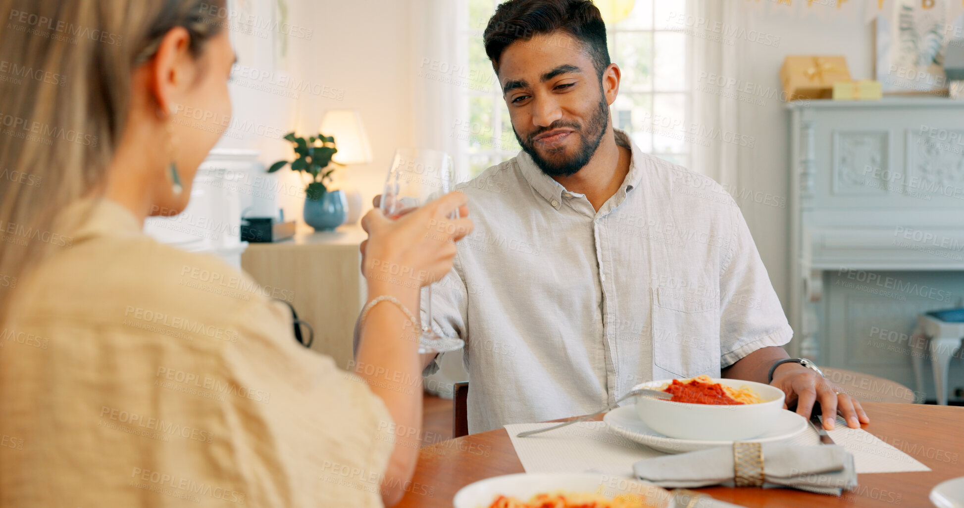 Buy stock photo Birthday cake, wine cheers and couple with dinner and Italian meal together for celebration. Love, alcohol and glass on date with pasta, dessert and anniversary food happy at dining table at a house