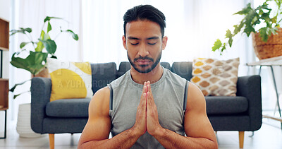 Meditation exercise, man yoga training and zen workout for spiritual health, relax for wellness and prayer hands for health in living room. Calm, healthy and Asian person praying for motivation