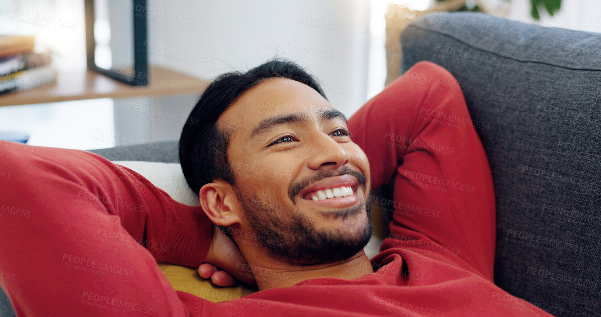 Buy stock photo Lying, face and man with smile on a sofa in living room after work for peace, freedom and happy thinking. Asian, person and relax on couch in lounge of home on a day off and weekend with happiness