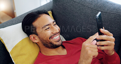 Sofa, happy and relax man with phone scroll, browse or search social media app for comedy or funny meme. Person lounge on living room couch with happiness, mobile smartphone and reading online comic