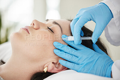 Buy stock photo Shot of a young woman having botox injections done at her doctors office