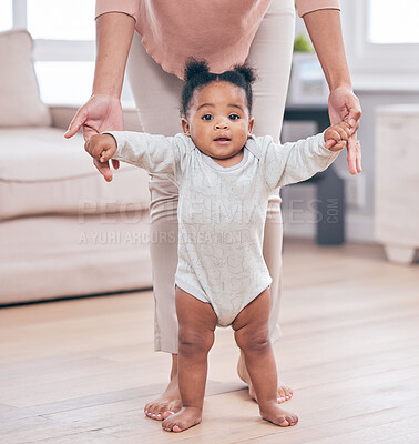 Buy stock photo Black baby portrait, walking and learning with mother in a living room lounge with mobility development. Floor, home and first steps of a young kid with mama help with love, care and support in house