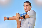 Beach fitness, health and man stretching arm for cardio exercise running, marathon training or body healthcare goals. Nature freedom, calm peace and athlete warm up for outdoor performance workout 