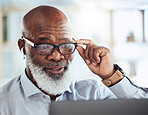 Black man, business glasses and reading laptop in corporate office, online news article and website. Mature manager, computer technology and earphones for video call, virtual working and management