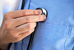 Hand, healthcare and stethoscope with a doctor in the hospital, testing his equipment before a consultation. Medical, heart and pulse with a medicine professional listening during a clinic checkup