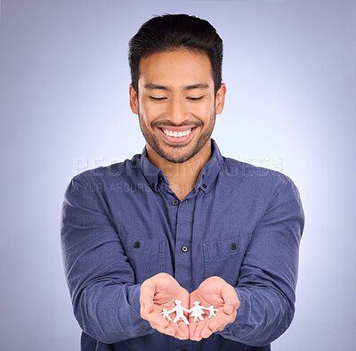 Buy stock photo Family, paper cutout in hands and man, smile with foster care and respect with trust on studio background. Happy male, connection and love with link, wellbeing of kids with adoption and parenthood