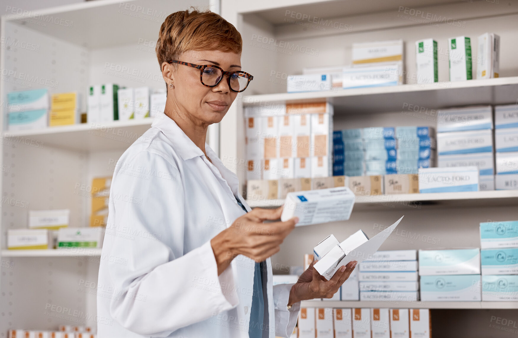 Buy stock photo Pharmacist, medicine and healthcare with a woman working and reading information on pills box. Black person in a pharmacy, clinic or shop for pharmaceutical, medical and health service or inventory