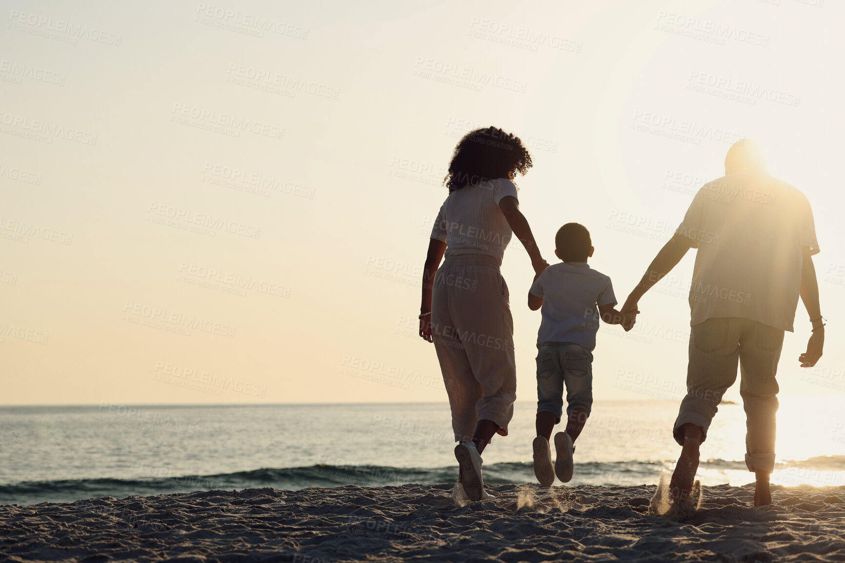 Buy stock photo Silhouette, beach and a family with kids by the ocean, holding hands in nature at sunset from the back. Summer, travel or mockup with a mother, father and child having fun while bonding at the sea