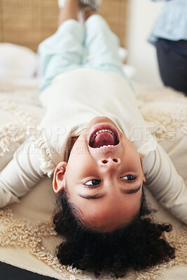 Buy stock photo Children, fun and bed with a black girl playing upside down in a bedroom of her home looking excited. Kids, happy and playful with a young female child shouting or screaming while lying in a house