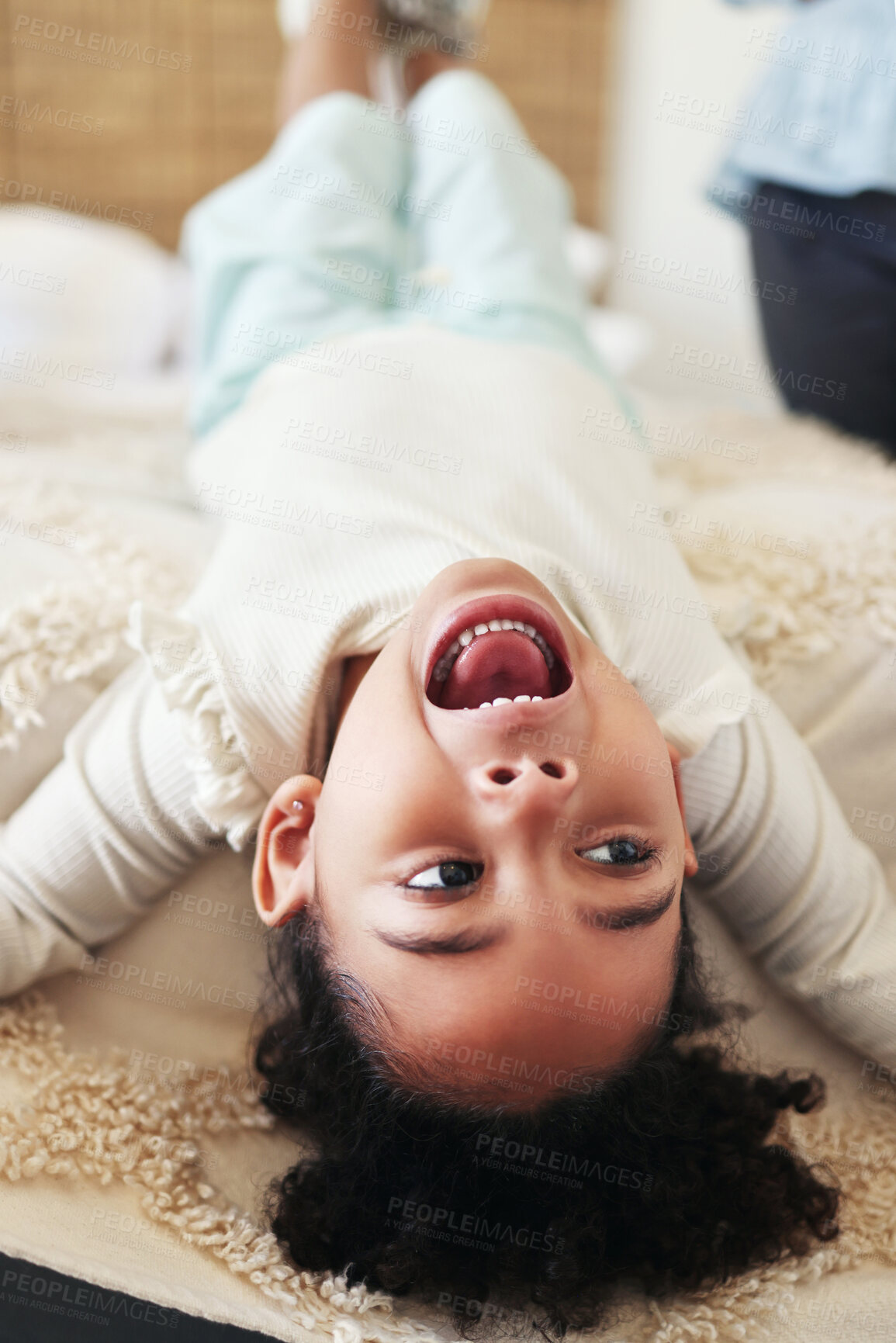 Buy stock photo Children, fun and bed with a black girl playing upside down in a bedroom of her home looking excited. Kids, happy and playful with a young female child shouting or screaming while lying in a house