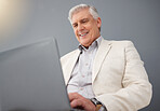 Senior business man, laptop and studio background for planning, online strategy and email website. Happy executive manager working on computer technology, corporate management and professional smile