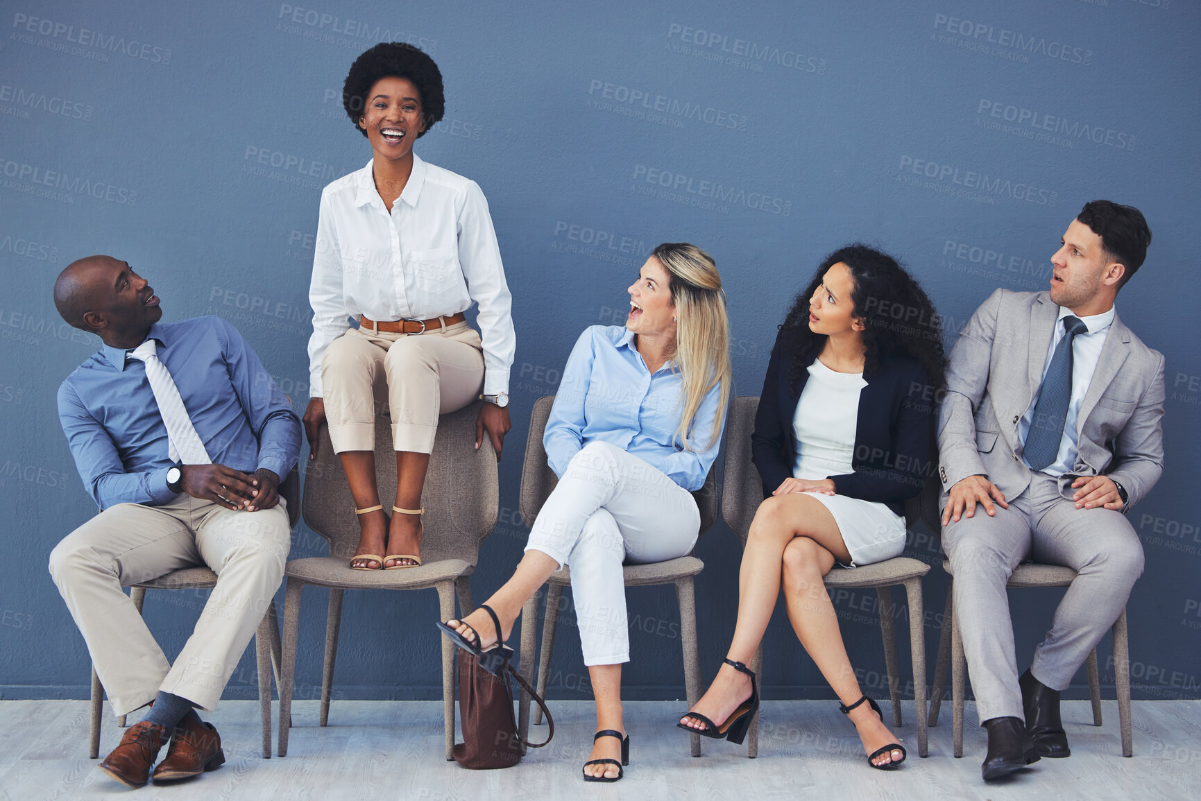 Buy stock photo Business people, hiring and waiting room of woman standing out against wall for interview, meeting or opportunity. Group of diverse interns looking at African American female candidate in recruitment