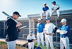 Sports, baseball and coach talking to the team on the field before a game, workout or training. Fitness, discussion and trainer planning a strategy with a male sport group before a match or practice.