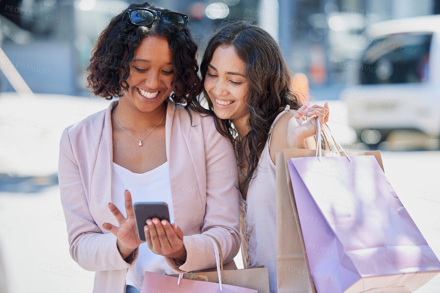 Buy stock photo Black woman, phone and online shopping with friends, street and bag with smile, meme or excited. Women, smartphone and texting in metro on social media app with happiness in summer with e-commerce ui